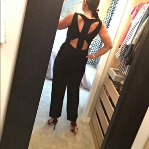 Black jumpsuit with cut-out details on back. SizeL